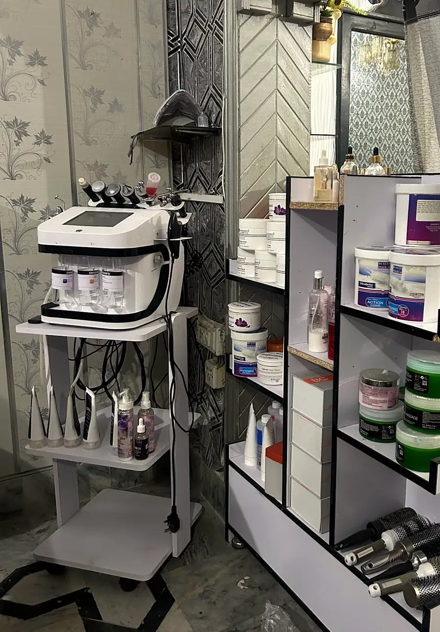 Hydra facial machine beside product shelves