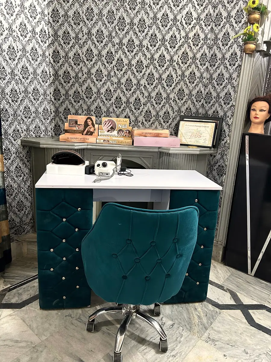 The nail corner with a teal velvet chair