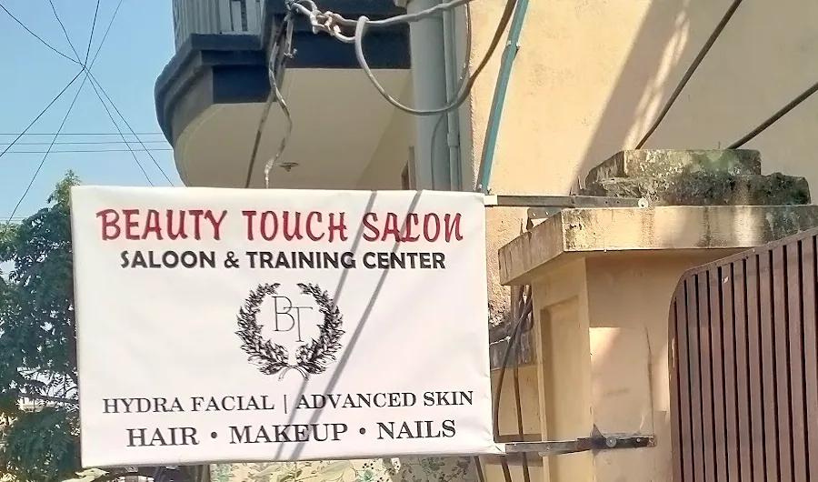 The Beauty Touch Salon board at the entrance